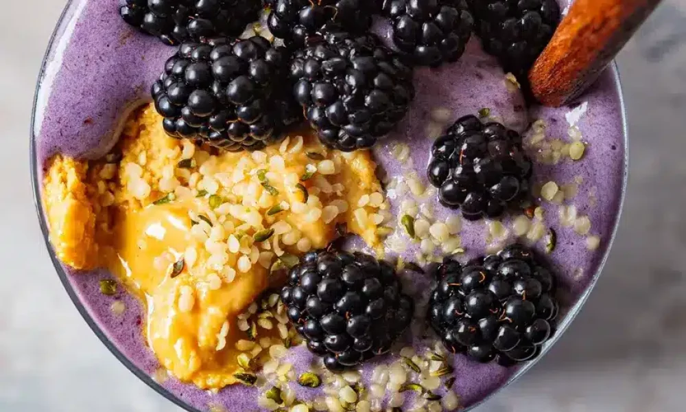 Berry smoothie with peanut butter and blackberries and hemp seeds
